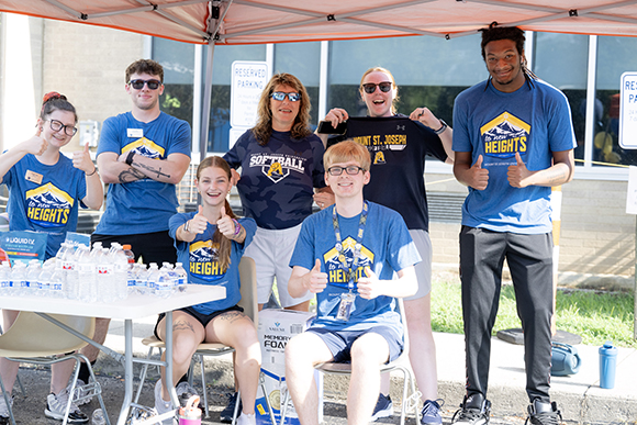 students and staff smiling during move in day