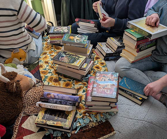 Mary Zink and her sisters, surrounded by books