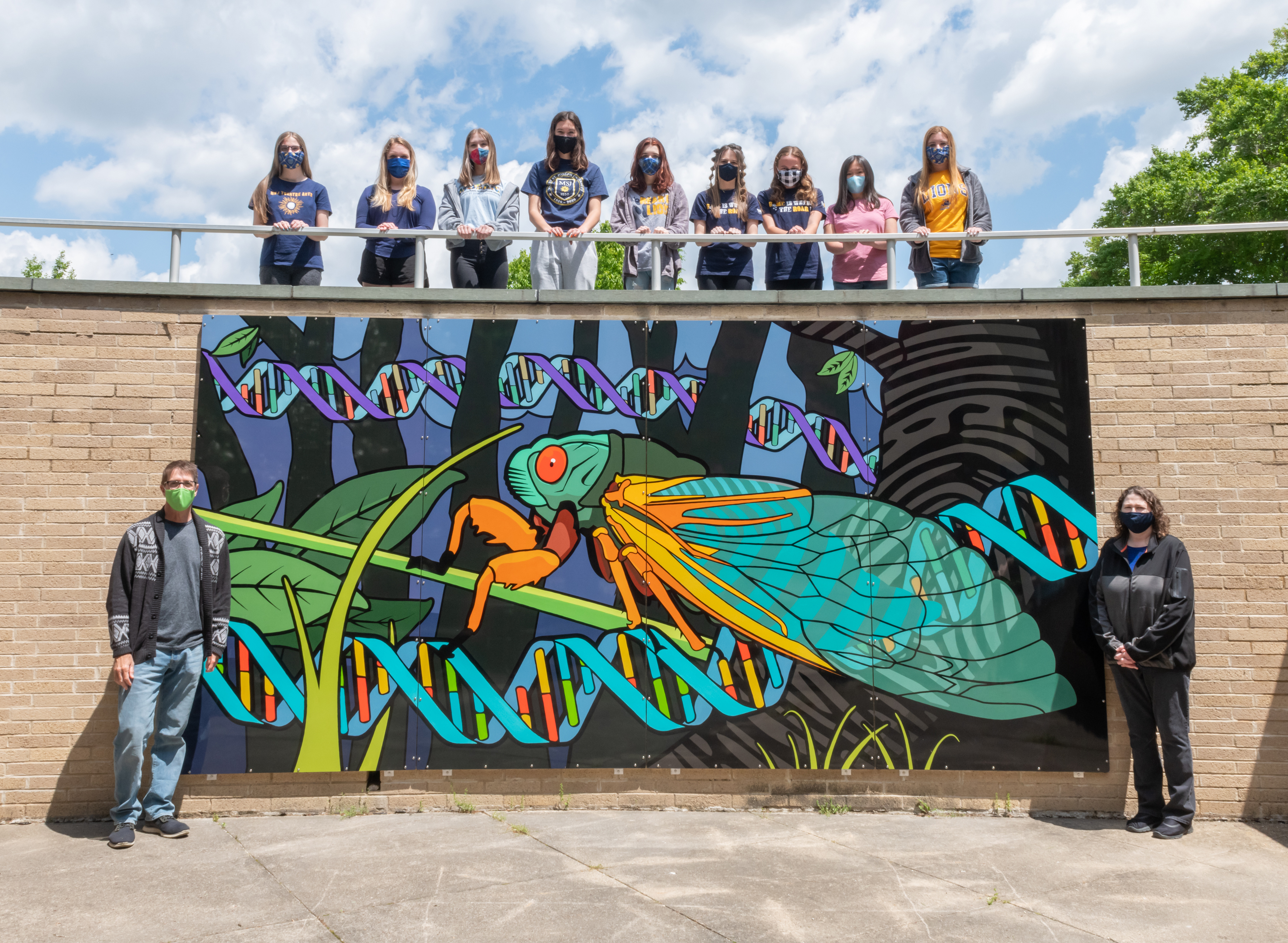 students gathered around outside mural