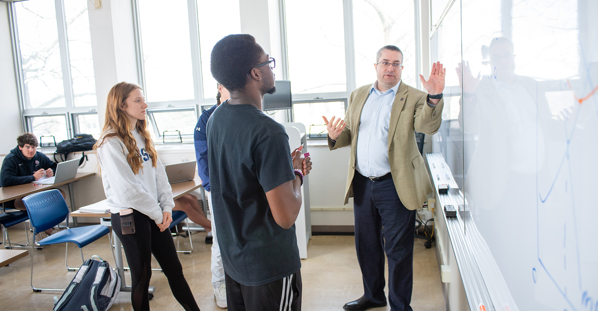 teacher pointing to picture for students in classroom