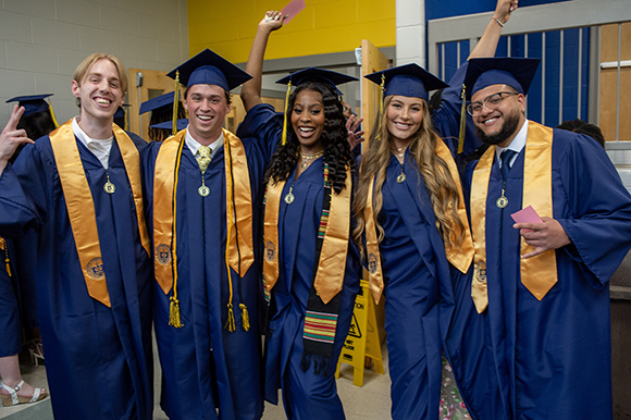 graduates standing next to each other at graduation.
