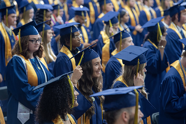 graduates in caps and gowns seated