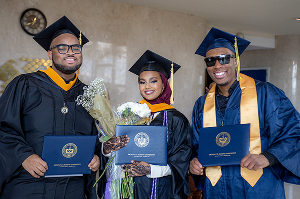 group of three graduates