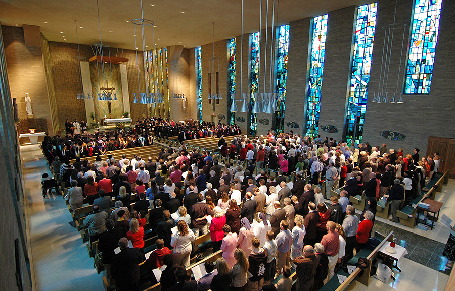 mater dei chapel full of people at pews for mass.