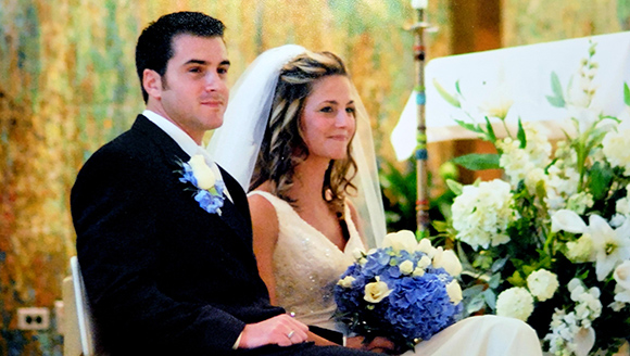 molly and anthony mclarnon sitting at chapel on wedding day smiling
