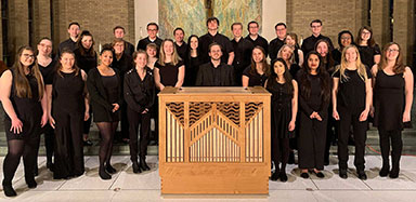 The MSJ Choir posing with and organ in Mater Dei Chapel.