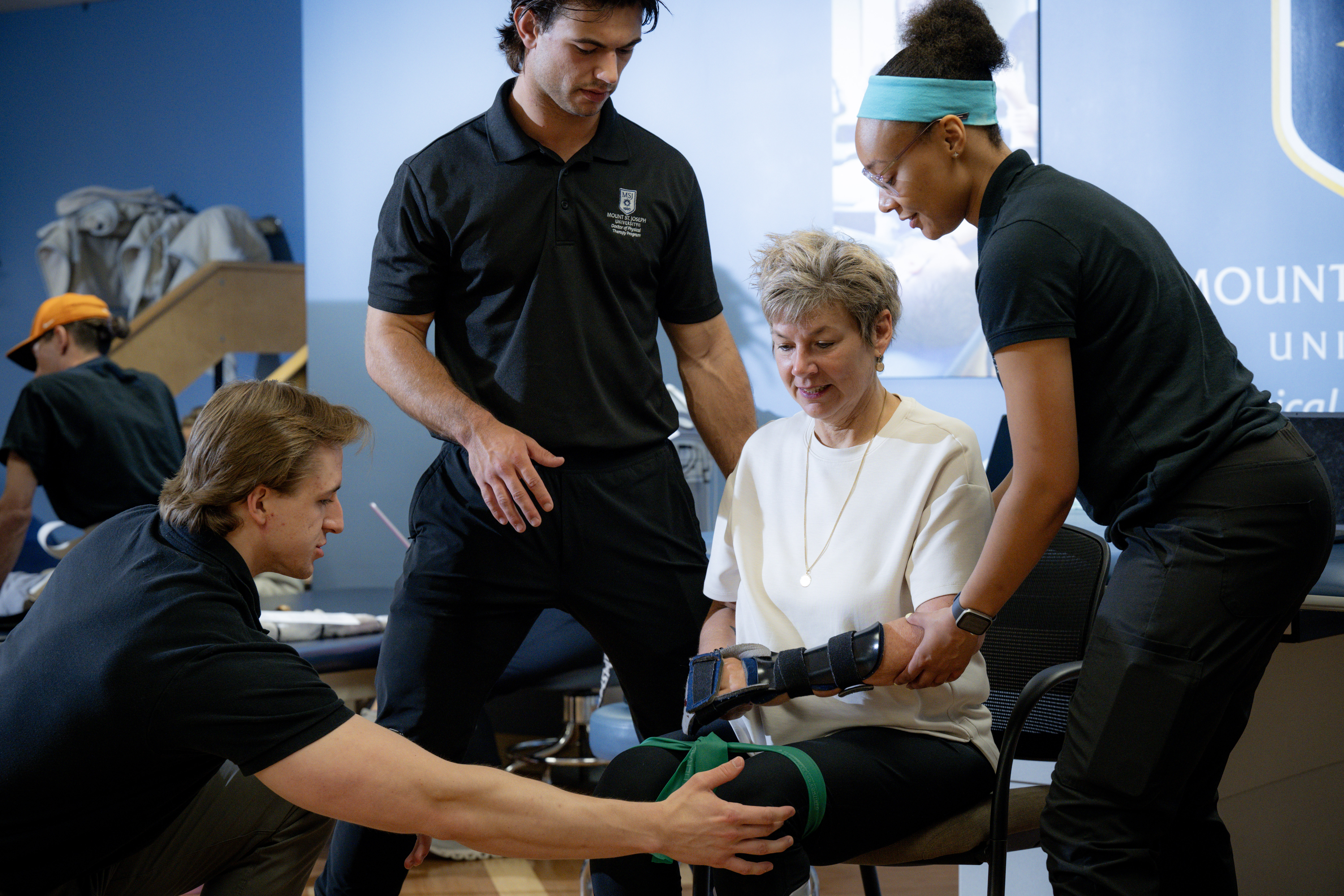 doctor of physical therapy students helping a woman walk