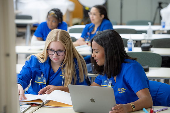 Nursing students studying with their laptop