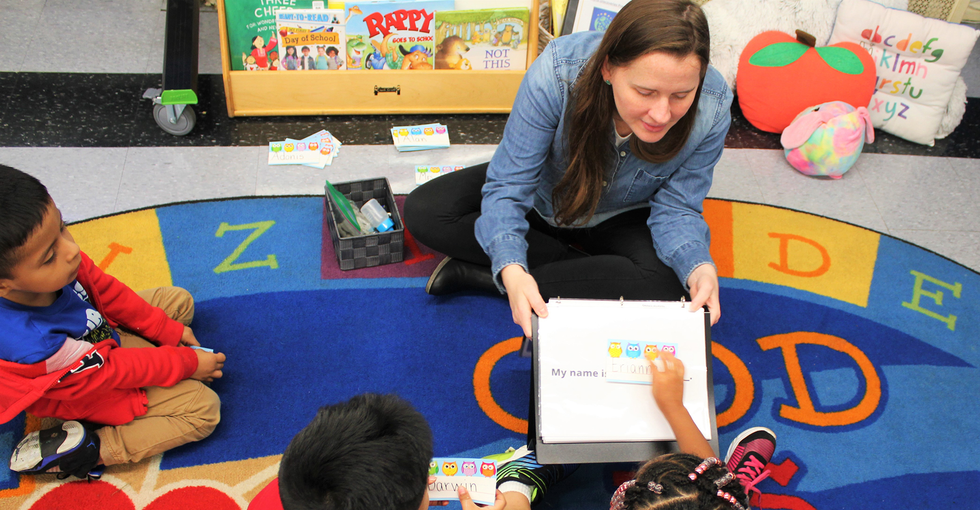 teacher pointing to picture for students in classroom