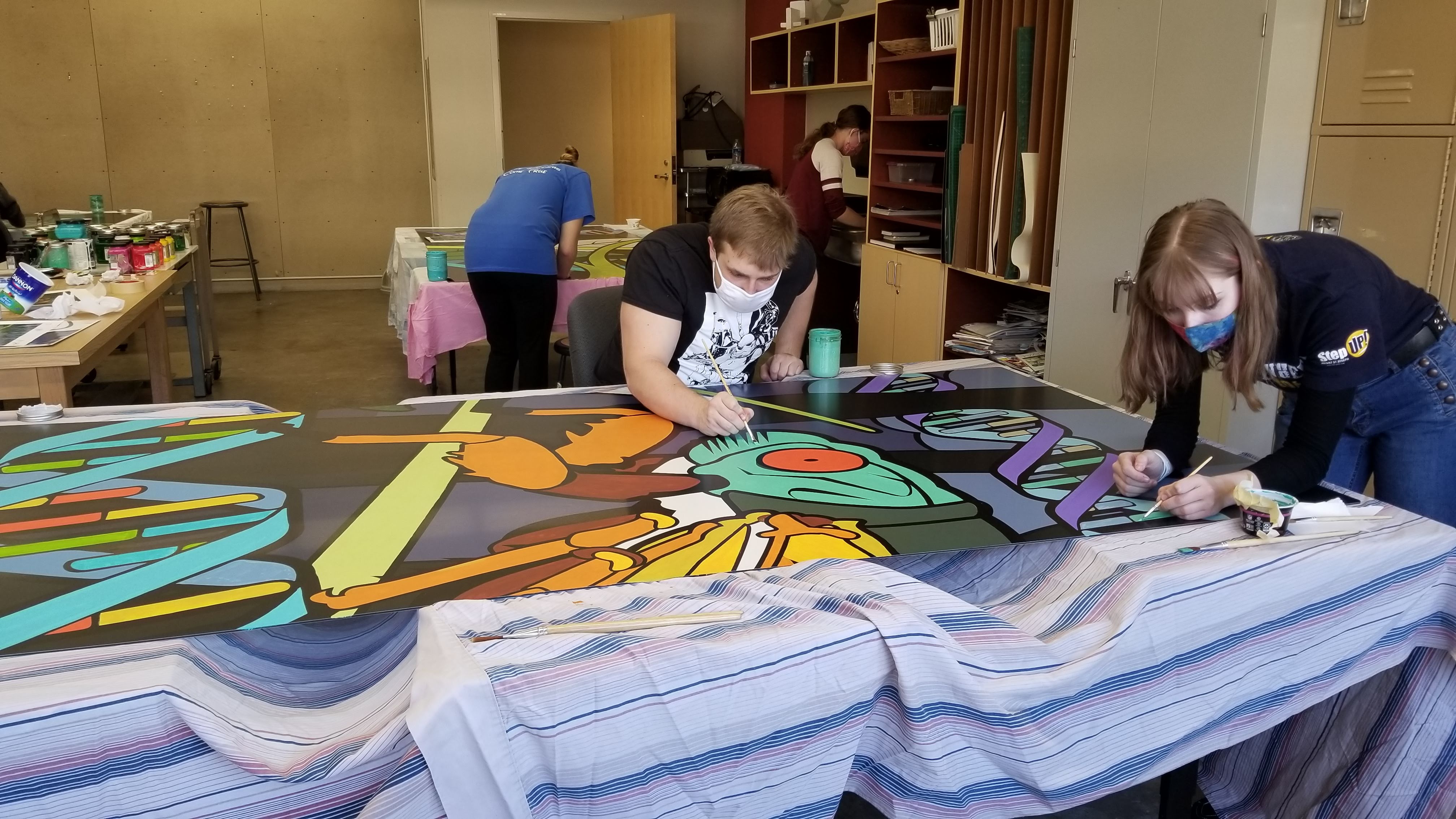 art guild students working on cicada mural