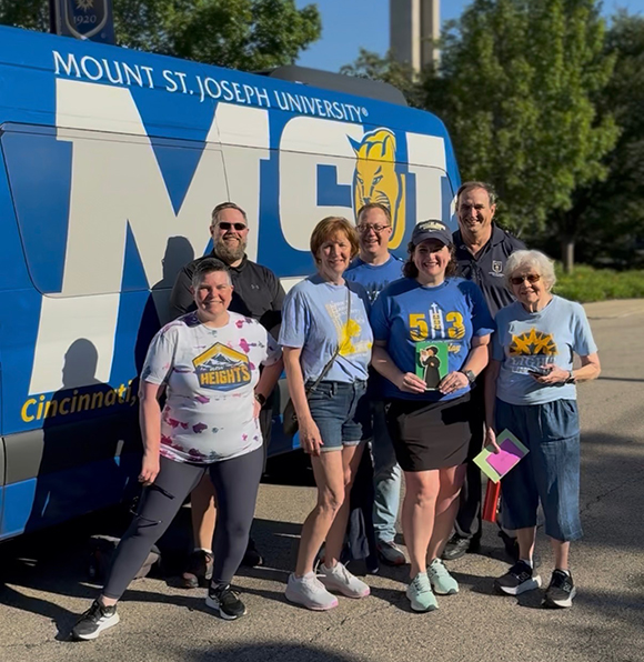emmitsburg group in front of MSJ van with chapel bell tower in the background