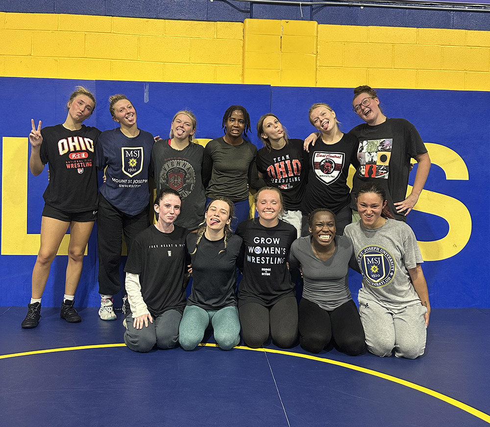 women's wrestling group smiling 