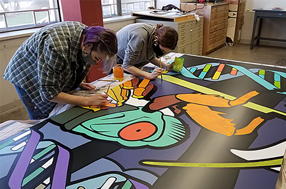Students paint a cicada mural